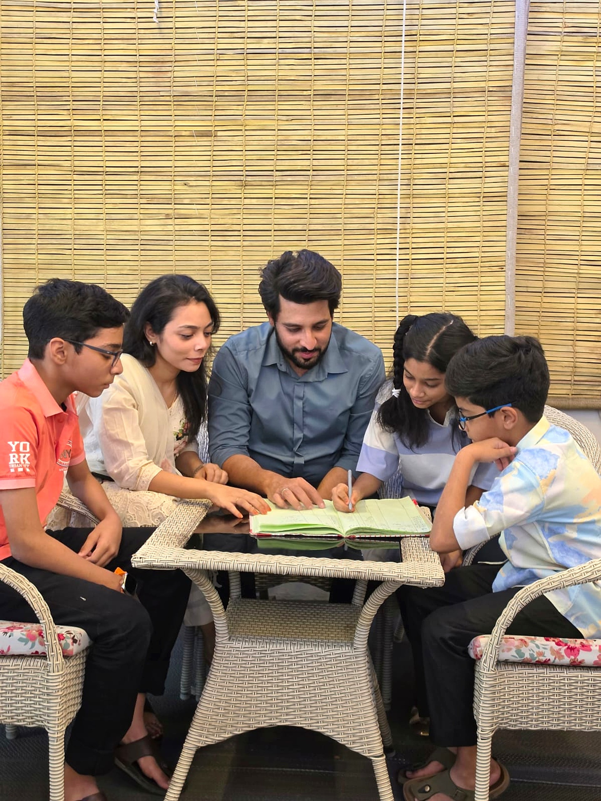 Happy children in a modern AI-powered classroom with tablets, books, smart board, and a friendly robot assistant